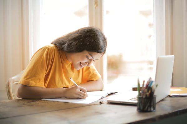 A smiling woman sat at a desk