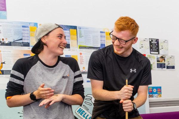 Two young people talking and laughing.