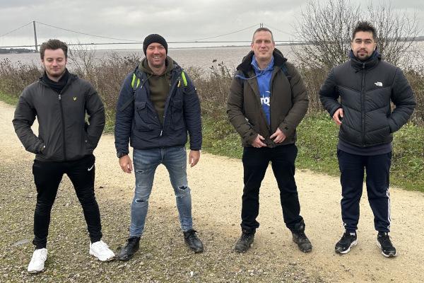 Group of four adults. The Humber Bridge is in the background.